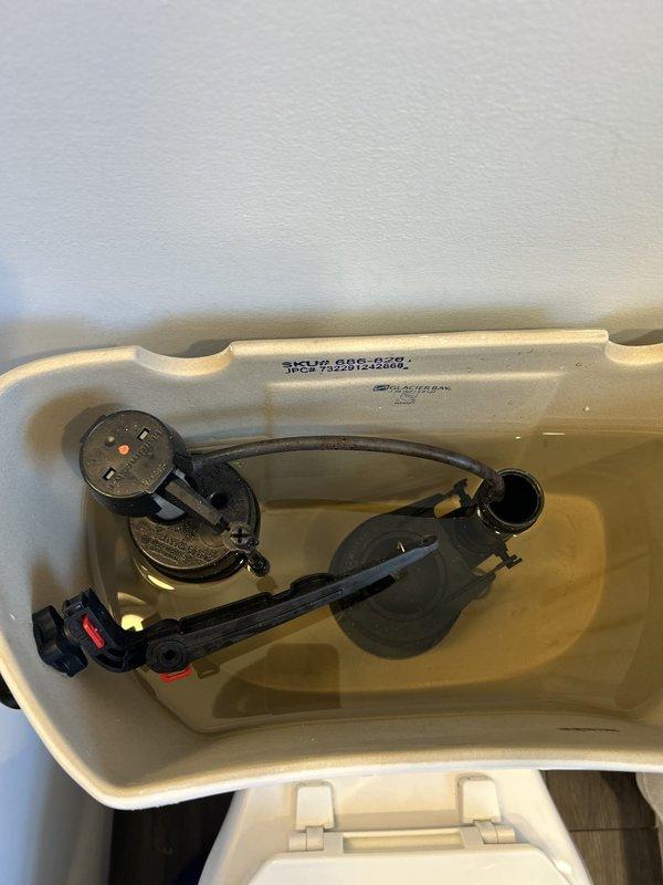Inspected the toilet tank for intermittent running and found the flush valve flapper and fill valve assembly showing wear, with sediment and staining present in the tank. Serviced the flapper, flush valve seat, and fill valve to restore a proper seal and correct water level, eliminating the periodic refill cycles. Tested multiple flush cycles to confirm the tank holds water, the fill valve shuts off completely, and the toilet operates without running.