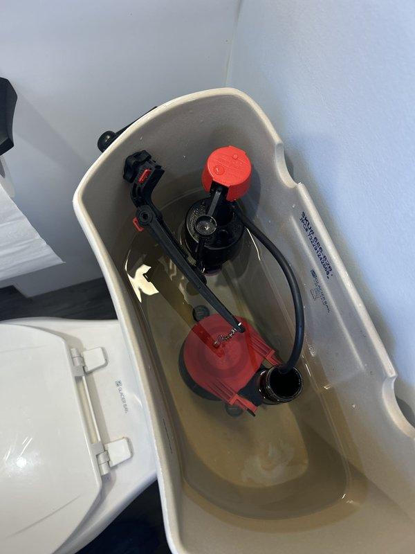 Inspected the toilet tank for intermittent running and found the flush valve flapper and fill valve assembly showing wear, with sediment and staining present in the tank. Serviced the flapper, flush valve seat, and fill valve to restore a proper seal and correct water level, eliminating the periodic refill cycles. Tested multiple flush cycles to confirm the tank holds water, the fill valve shuts off completely, and the toilet operates without running.