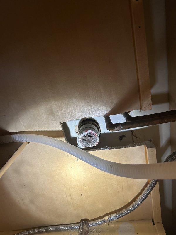 Responded to a warranty call for a slow-draining sink and a suspected leak at previously installed drain piping. Inspected the sink drain assembly, strainer flange, and PVC trap, then cleared the obstruction, tightened the slip-joint connections, and confirmed proper drainage with no leaks at the fittings.