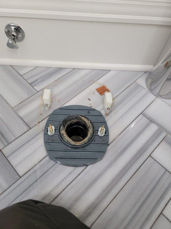 Pulled the toilet to gain direct access to the closet flange and drain line in order to clear the reported blockage. Inspected the exposed flange, which showed heavy residue from the old wax seal, and left the closet bolts in place for toilet reinstallation.