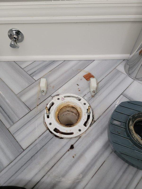 Pulled the toilet to gain direct access to the closet flange and drain line in order to clear the reported blockage. Inspected the exposed flange, which showed heavy residue from the old wax seal, and left the closet bolts in place for toilet reinstallation.