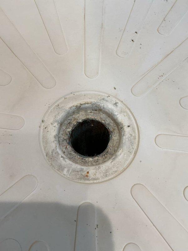 Completed the sold plumbing repair in the shower area, which required a helper and extension ladder for overhead access. Inspected the shower drain, which was missing its cover and showed heavy mineral buildup, debris, and minor surface rust around the drain ring, and verified that the surrounding glass enclosure, tile, and ceiling fixtures were undamaged.
