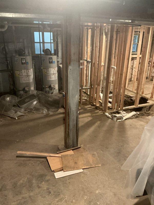 Performed an on-site assessment of the residential basement drain and sewer system in preparation for an estimate. Inspected the exposed PVC drain piping routed through the new wall framing, as well as the excavated trench in the concrete slab where drain line segments are staged. Evaluated site conditions, including access around the water heaters and support column, to determine the scope of work required for completing the drain installation.