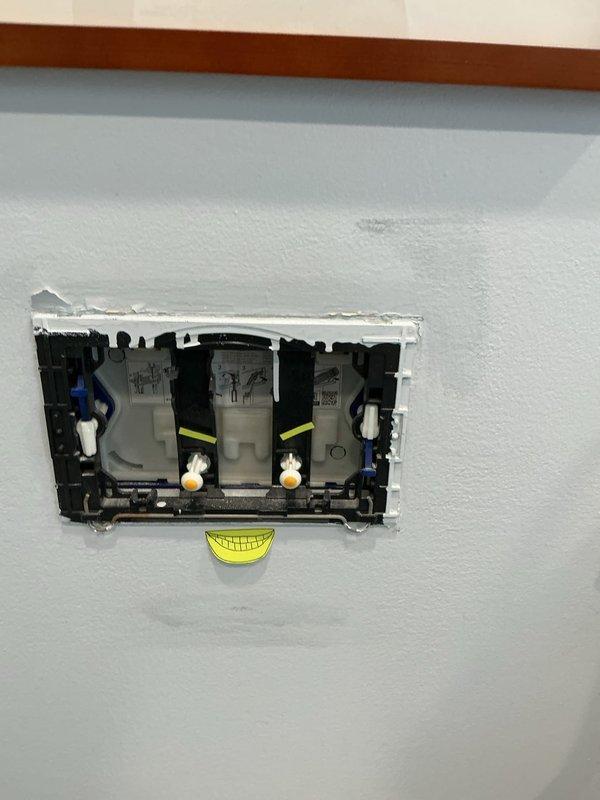 Serviced a Geberit in-wall toilet that was running continuously by removing the flush plate and accessing the concealed actuator mechanism. Inspected, adjusted, and reseated the actuator plungers and linkage to restore proper flush valve seating and stop the constant water flow. Reinstalled the flush plate and verified correct operation through multiple flush cycles, with no further running.
