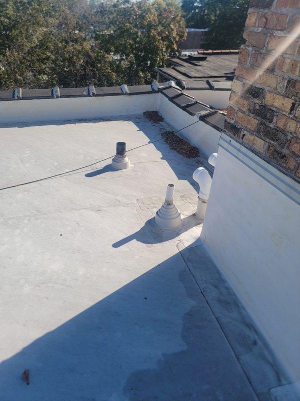 Performed annual preventive maintenance on the building's main drain stack, accessing the roof to inspect the vent penetrations and flashing boots and to clear dried leaves and debris from around the vent terminations and parapet base. Rodded the stack from the roof access point to remove buildup and verify an unobstructed flow path through the main line, leaving the system clear and operating properly.