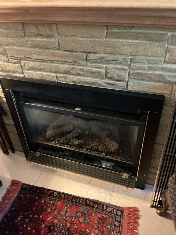 Replaced the gas line shutoff valve in the basement and performed a gas pressure test on the system to verify leak-free operation. Inspected the surrounding aged iron and galvanized gas piping and threaded fittings, noting loose low-voltage wiring draped across the piping. Also inspected the gas fireplace insert serviced by the line.