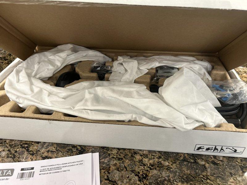 Installed a customer-supplied Delta single-handle pull-down kitchen faucet and replaced the existing angle stops under the kitchen sink with new emergency stops, including the dishwasher supply stop. Water was shut off for the duration of the work, and all supply connections were completed with braided stainless steel supply lines. Tenant was advised to coordinate with building management to schedule any future water shutdowns.