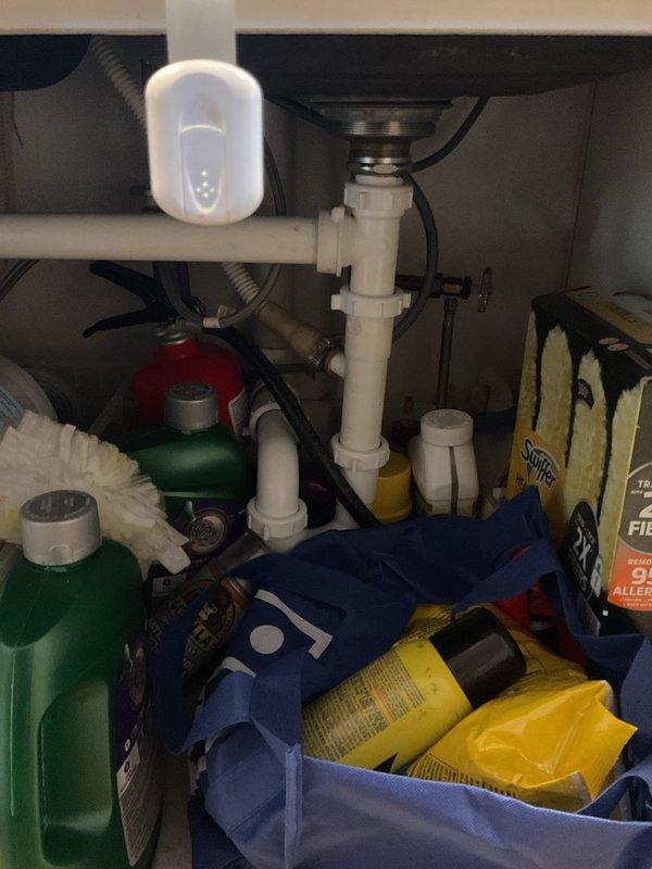 Responded to a clogged kitchen sink with standing water in the basin. Inspected the P-trap and drain assembly beneath the sink, cleared the obstruction from the drain line, and restored proper drainage. Verified unobstructed flow through the basin and drain connections, with no leaks observed at the slip-nut fittings.