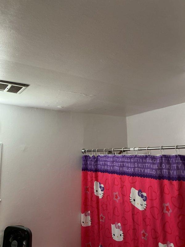 Responded to a warranty callback for a recurring leak at the tub/shower assembly and inspected the shower valve, tub spout, and surrounding wall and ceiling areas for the source of water intrusion. Verified the condition of the tub-to-wall surround seam and associated sealing, noting heavy mildew and buildup along the joint, and checked adjacent ceiling surfaces for signs of moisture migration. Recommend cleaning and re-sealing the tub-to-surround joint and continued monitoring of the valve and spout connections to prevent recurrence.