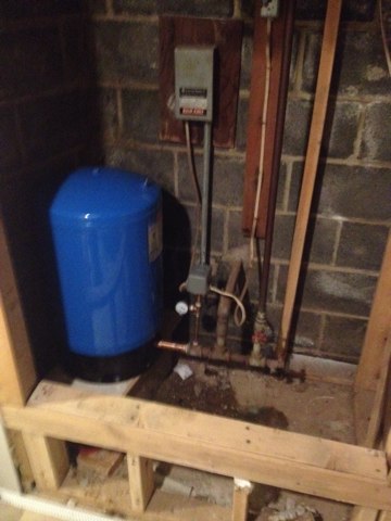 Install new well tank with new pressure switch and gauge. A sure sign of a bad well tank is a fluctuations  in water pressure and a clicking sound in the basement.