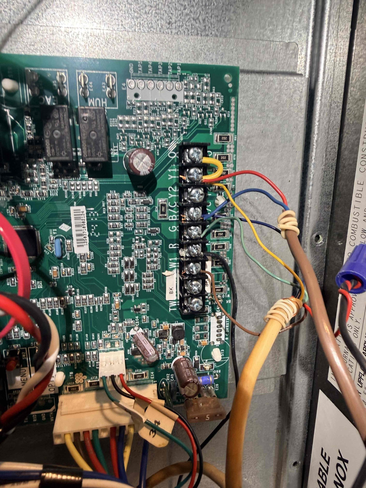 During the inspection, the unit was non-operational, displaying an E17 error code. I began by examining the blower motor and ensuring its continuity. I then verified that 120 volts were present at the motor. However, no 12 volts were detected on the communication wires between terminals 1 and 3. This indicated a potential issue with the control board, which is responsible for sending the necessary voltage. To resolve the problem, I ordered a replacement control board and a motor, as it's possible the motor could also be defective.