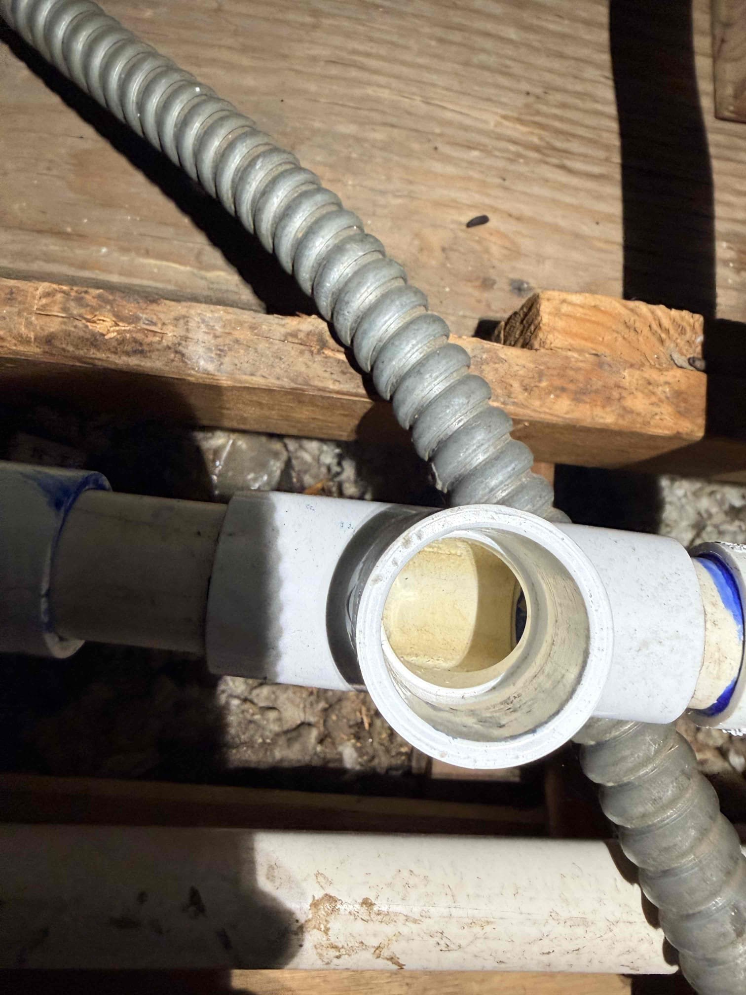 Upon inspection, I identified water leakage around the condenser unit. The drain was functioning correctly, but the drain line had detached due to inadequate gluing. I carefully re-glued both drain lines, ensuring a secure fit. The condenser pad remained intact, preventing any damage. With the lines properly sealed, the system is now stable, and no further leaks are anticipated. The job is complete.
