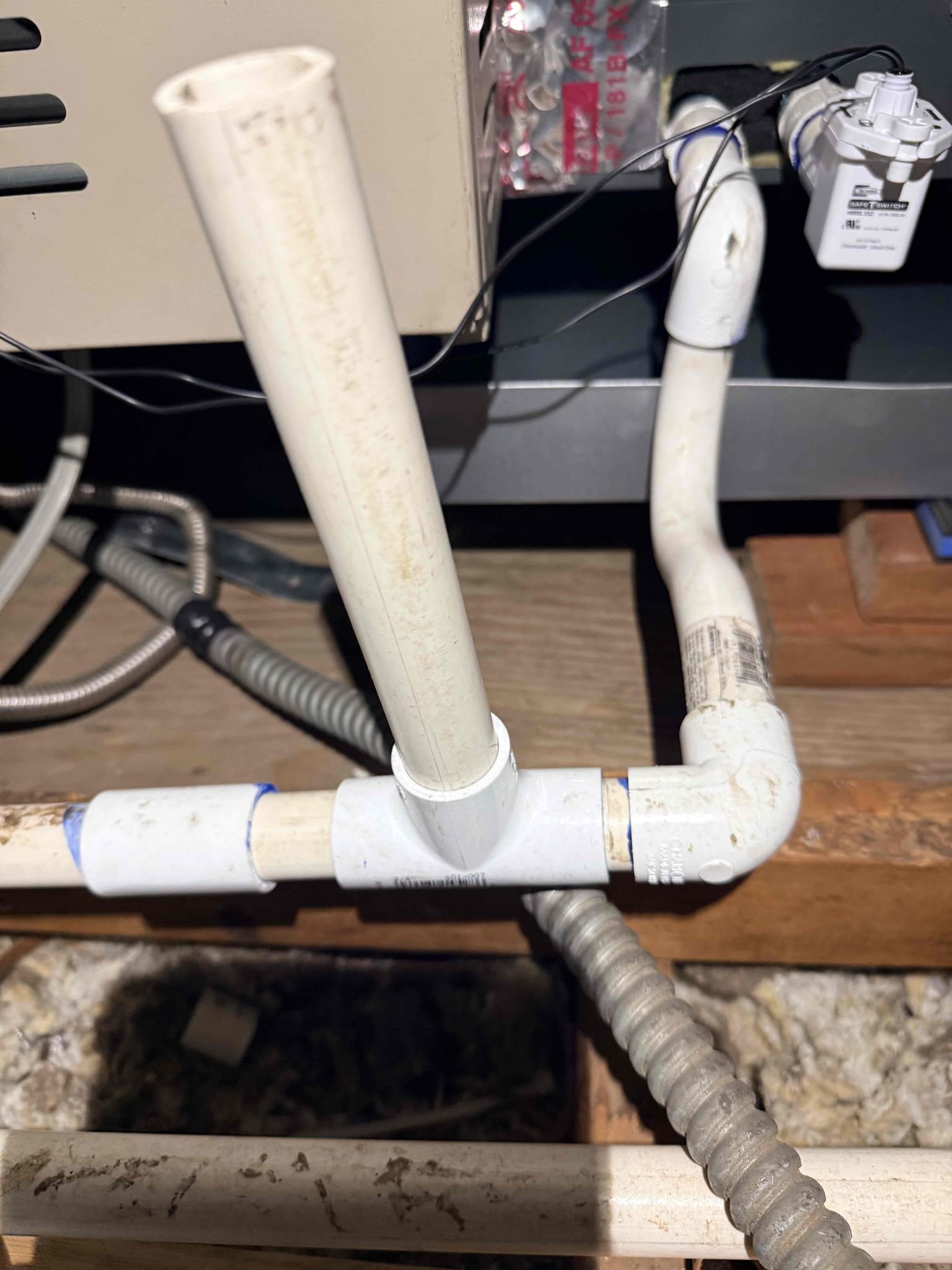 Upon inspection, I identified water leakage around the condenser unit. The drain was functioning correctly, but the drain line had detached due to inadequate gluing. I carefully re-glued both drain lines, ensuring a secure fit. The condenser pad remained intact, preventing any damage. With the lines properly sealed, the system is now stable, and no further leaks are anticipated. The job is complete.