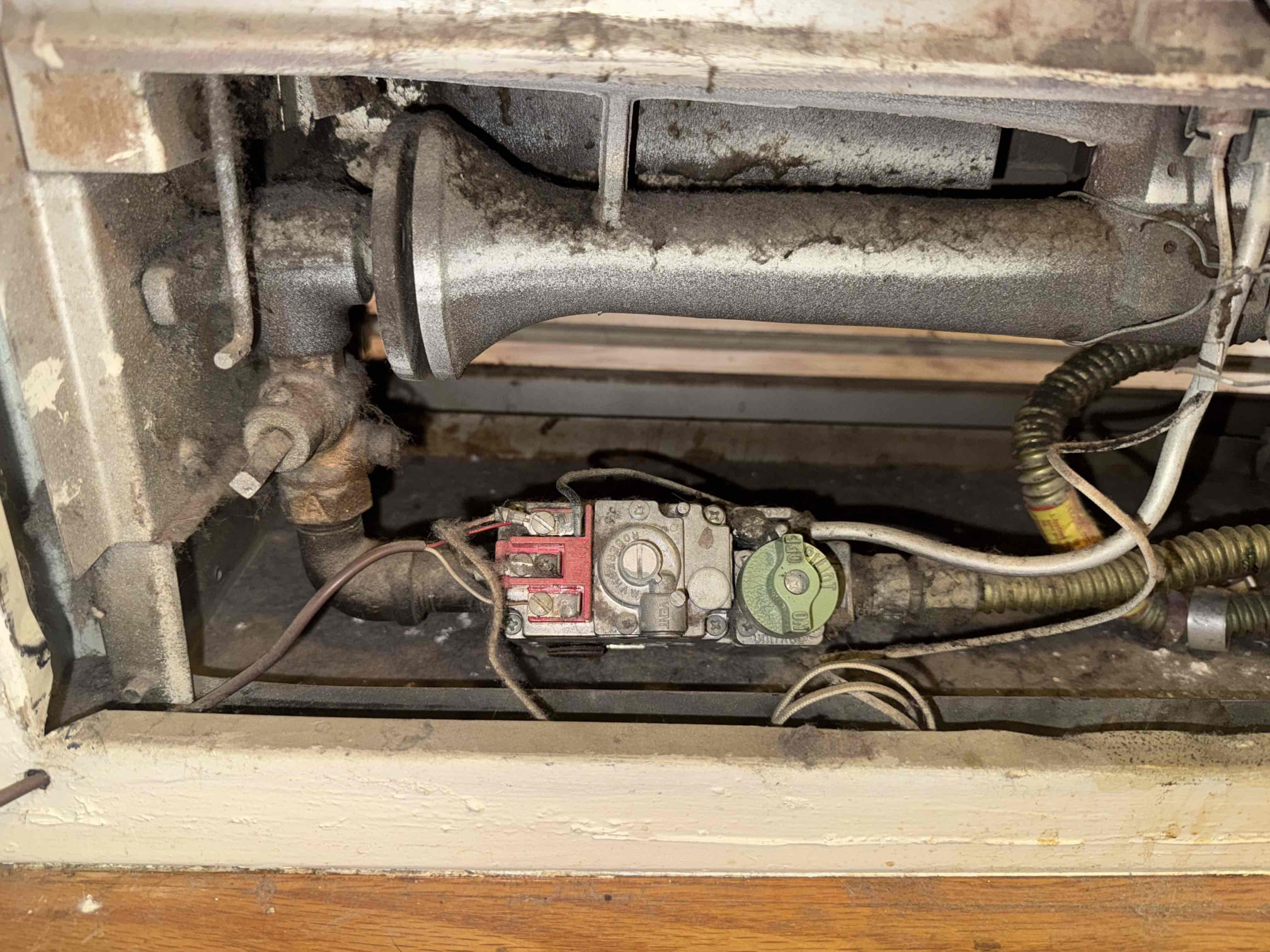 I conducted a thorough diagnostic inspection of the wall furnace due to operational and safety concerns. I examined the burner compartment, pilot assembly, thermopile, gas valve, and safety controls. The thermopile tested at approximately 480 mV DC, indicating it is generating sufficient power. However, a gas leak was detected at the pilot assembly, which showed significant age-related deterioration, corrosion, and contamination. Additionally, heavy dust and debris accumulation were found throughout the burner compartment. Due to the active gas leak, I recommend repairing the pilot assembly immediately. Continued operation is not advised until the leak is corrected. I conducted a thorough diagnostic inspection of the wall furnace due to operational and safety concerns. I examined the burner compartment, pilot assembly, thermopile, gas valve, and safety controls. The thermopile tested at approximately 480 mV DC, indicating it is generating sufficient power. However, a gas leak was detected at the pilot assembly, which showed significant age-related deterioration, corrosion, and contamination. Additionally, heavy dust and debris accumulation were found throughout the burner compartment. Due to the active gas leak, I recommend repairing the pilot assembly immediately. Continued operation is not advised until the leak is corrected.