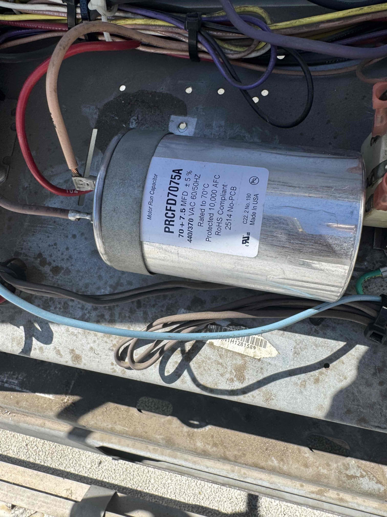 I conducted a thorough diagnostic evaluation of the air conditioning system. Verified the condenser fan motor wiring, electrical connections, and capacitor value, all of which were correct. The compressor startup and running amperage were within acceptable limits. Initial pressures were high and unstable, but stabilized at 110 psig suction and 414 psig discharge, with a 28°F temperature split. This suggests good cooling performance despite moderately dirty coils. The system likely has an incorrect refrigerant charge or non-condensable gases, requiring complete recovery, evacuation, and recharging to ensure long-term reliability.