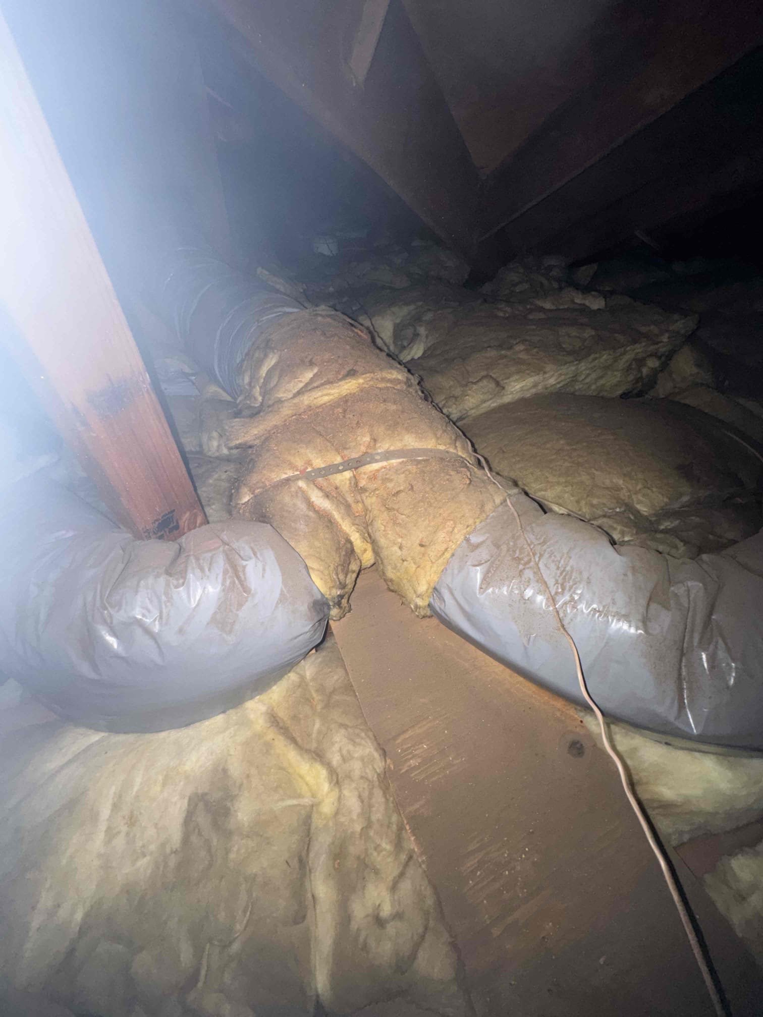 Los Angeles, CA - We replaced three deteriorated supply ducts in the rear portion of the home with new insulated R-8 flex duct to improve airflow and comfort. The old ducts were restricted, contributing to poor airflow in the rear bedrooms. The new ductwork was installed, sealed, and supported according to manufacturer standards. During the repair, we also inspected the remaining duct system and found the supply plenum uninsulated, causing heat gain in the attic. The return configuration is original and could benefit from modernization. The homeowner chose to complete only the airflow repair, but we recommended replacing the remaining aging ductwork and installing new insulated supply and return plenums for better airflow balance, efficiency, and comfort.