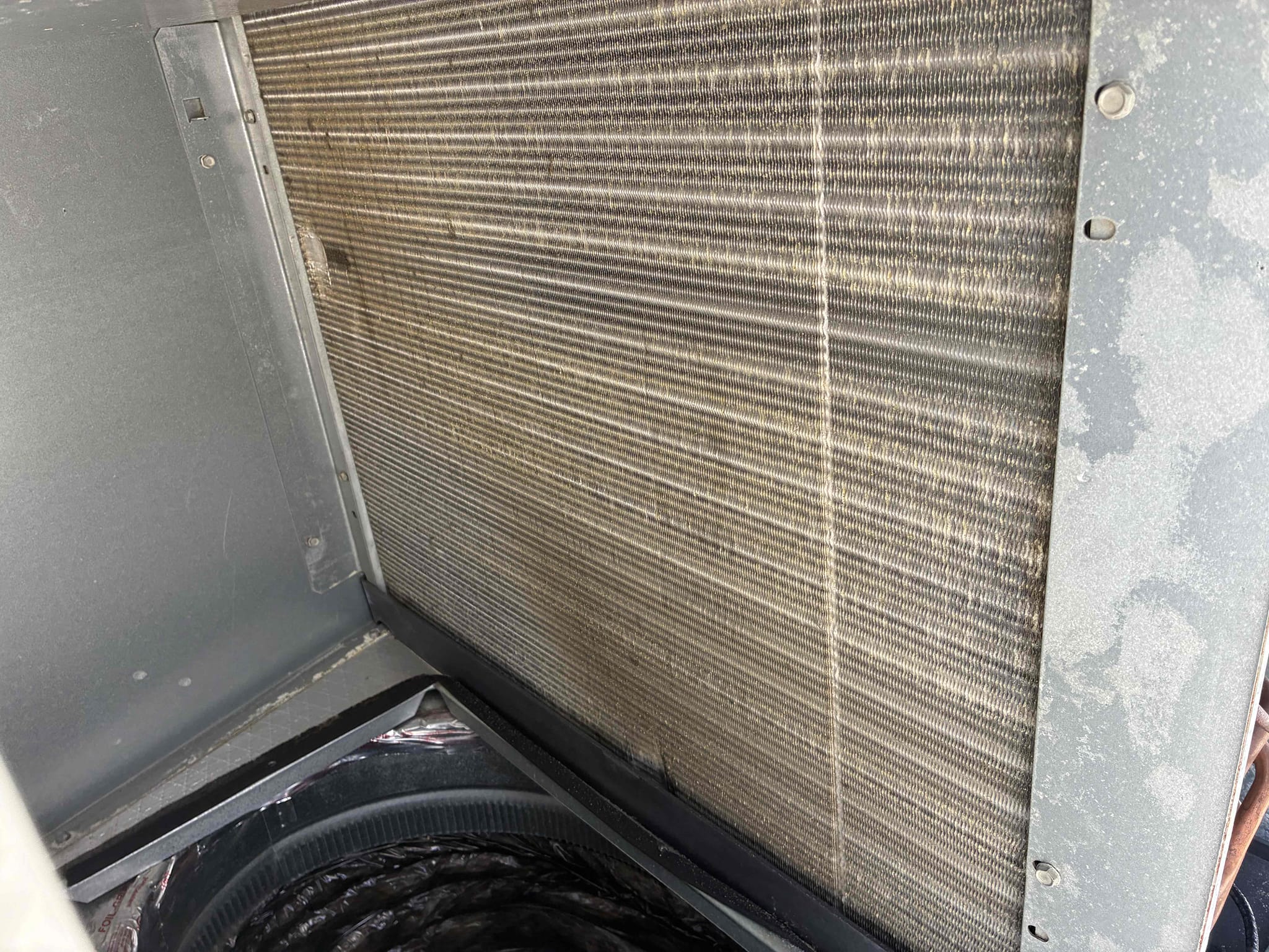 Completed a maintenance and safety inspection on a 2021 American Standard package unit. Changed the dirty 14x24x1 filter. Checked temperatures and refrigerant pressures on the roof, finding normal readings. Noted a light brown tint on the evaporator coil and dirt on the blower wheel, recommending a cleaning for next summer. Discovered the condensation drain line was broken and improperly connected, causing water to drain onto the roof. Advised securing the piping to prevent roof damage and drainage issues.