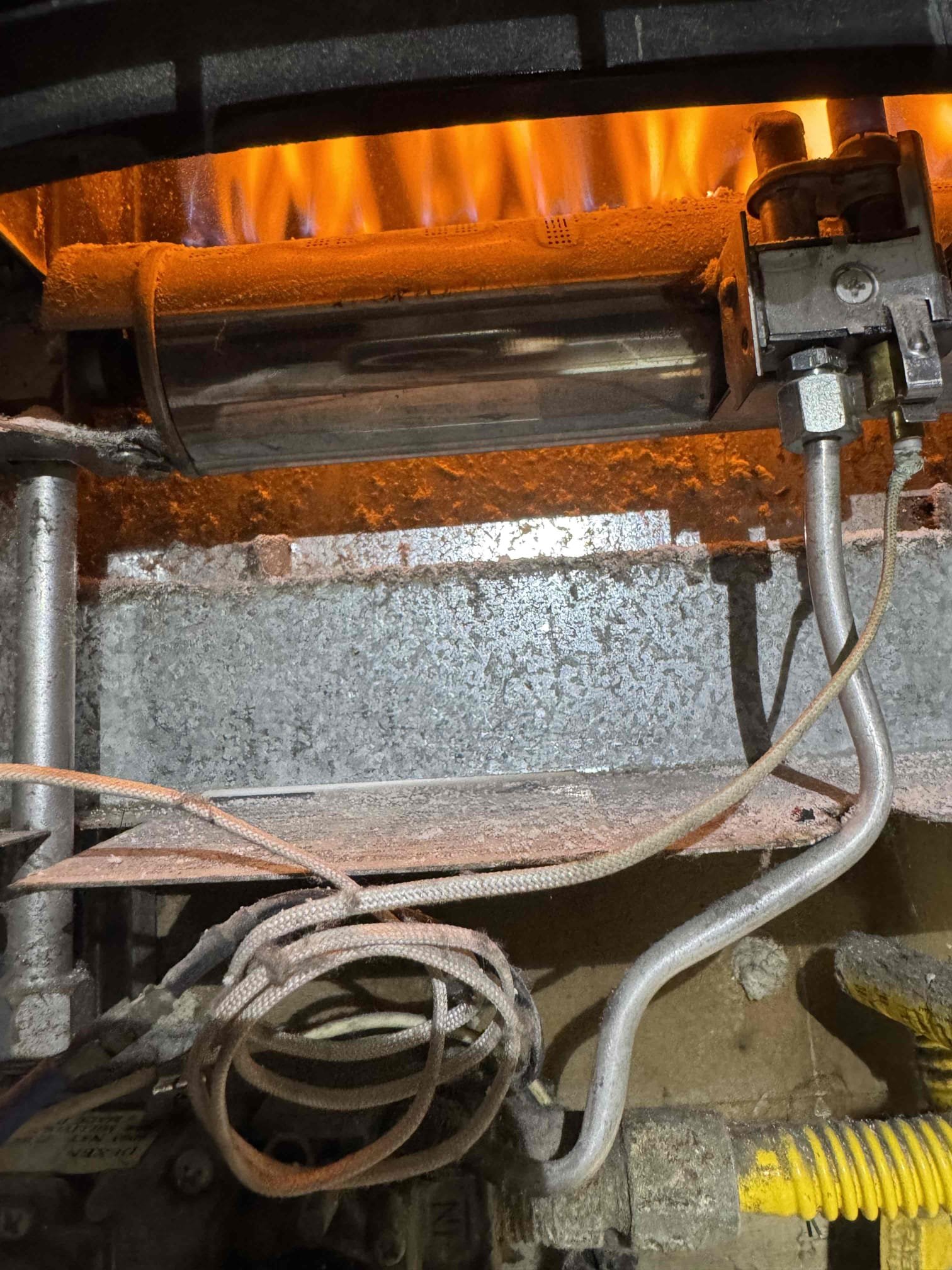 I conducted a diagnostic on a Williams wall furnace experiencing intermittent/no heat issues. Thermopile output was measured at 167 mV, but the pilot flame extinguished under load, hindering main burner ignition. Inspection revealed a heavily soot-coated thermopile and undersized radio wire in the thermostat circuit. After cleaning the thermopile and securing wiring connections, the furnace temporarily resumed operation. While operational now, I recommend replacing the thermopile, cleaning the pilot assembly, and installing proper thermostat wiring for long-term reliability. Photos were taken to document the system's condition.