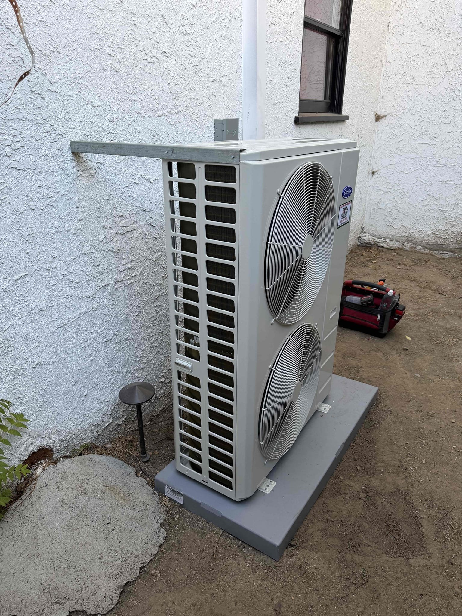 We completed a comprehensive heat pump conversion, LADWP qualified. The installation involved removing and disposing of existing equipment. We connected a 115V/220V air handler to the electrical system, installed a 5-ton Carrier Performance Inverter Heat Pump condenser, and a matching air handler. Electrical components like the service disconnect box, whip, and pig tail were installed, along with a condensation line, drain pan, and condenser pad. Safety features included an SS2 safety shut-off switch. The Carrier thermostat was connected to the low voltage line and supply plenum. Standard warranties and a 1-year labor warranty are provided.