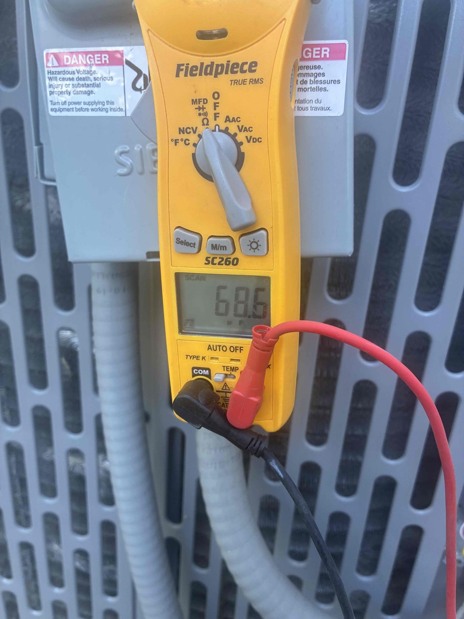 Upon arrival, I inspected a Nordyne/Ameristar System that was not providing cooling and had a thermostat cycling on and off. The issue was confirmed during the inspection. I accessed the attic and discovered that the furnace/air handler access door was not properly secured, causing the door safety switch to disengage. I reattached the door switch, and the system started operating correctly. While the blower was running, I noticed a rattling noise in the attic, which was not audible inside the home. The tenant mentioned that another contractor had been there a month ago for a water leak and did not secure the equipment door properly. I performed a maintenance inspection and found the 70/5 dual run capacitor reading low at 67.4/3.5, below the acceptable range. I recommend replacing the capacitor to prevent future breakdowns. Additionally, I changed the 20x25x1 filter for the client. The system is now operating correctly.