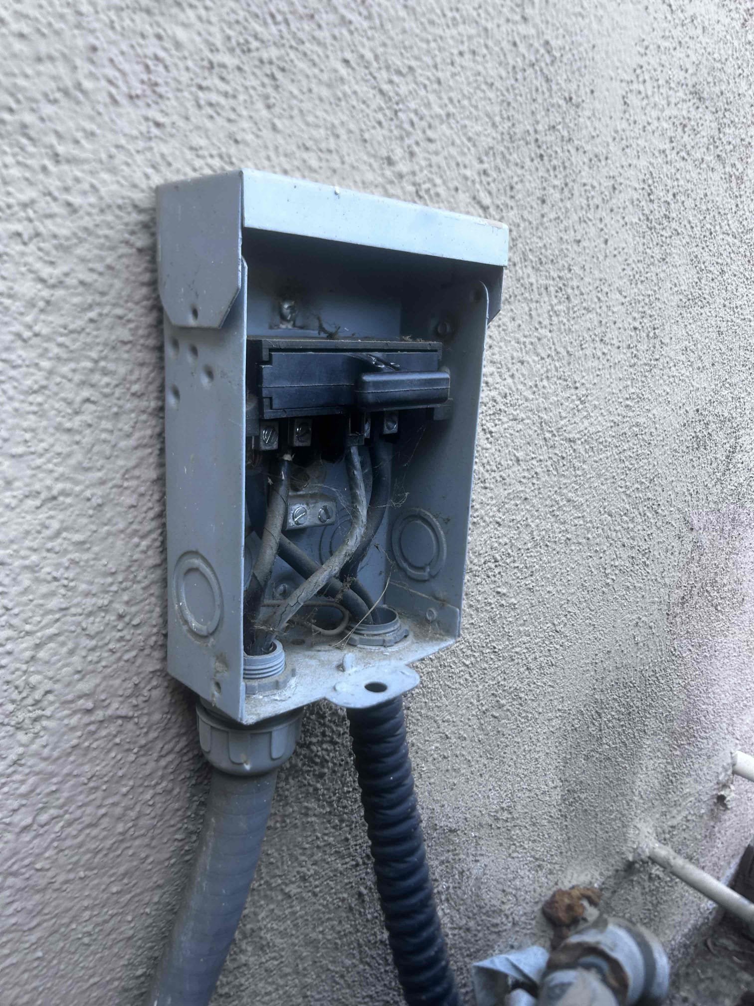 Upon arrival, the AC system was not cooling. The condenser unit was not operational due to a tripped 50-amp main breaker. After resetting the breaker, the cooling system functioned, but the condenser fan motor exhibited higher-than-normal amperage draw. The system was also low on R22 refrigerant, which has been phased out since 2010. The unit was noticeably dirty, necessitating a deep clean. Given the system's age and condition, I recommend replacing the condenser fan motor and topping off the R22 refrigerant. Due to the system's age, I strongly advise considering new equipment for a more reliable and efficient solution.
