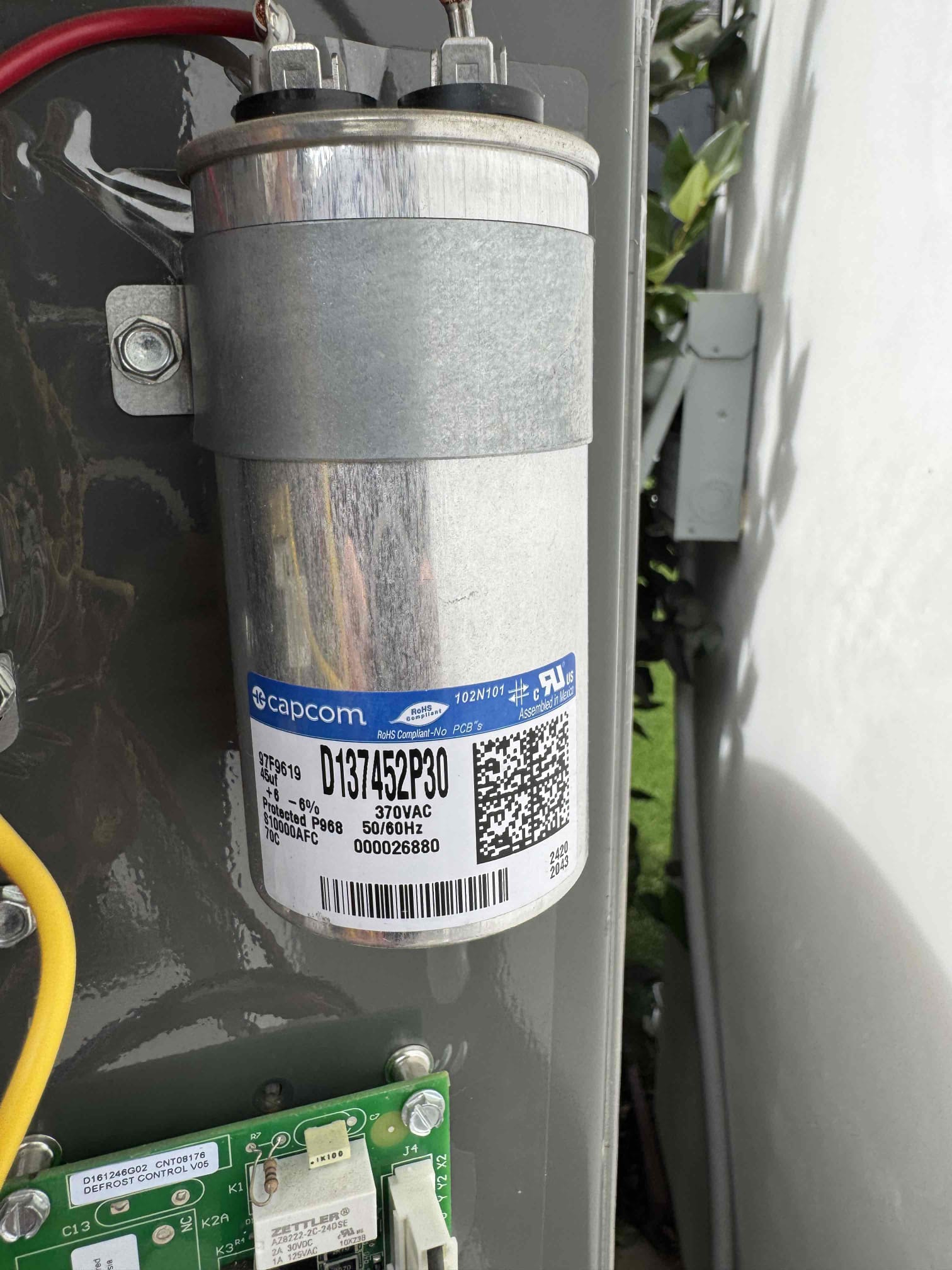Upon arrival, I first checked the system's cooling demand and found the outdoor condenser fan was not operating. I verified the capacitor and contactor, both of which tested within manufacturer specifications. I confirmed 240 volts at the ECM condenser fan motor during operation. The compressor started and ran normally, but the condenser fan motor did not respond. I inspected the wiring harness and connectors, finding no significant damage. After thorough testing, I diagnosed a failed ECM condenser fan motor assembly and proceeded with the replacement.