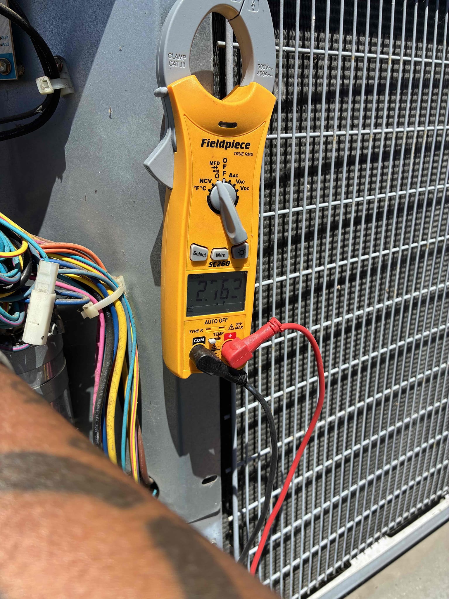 Upon inspection, the 2014 Carrier Heat Pump was not cooling effectively. The indoor blower fan was operational, but the air filter was dirty, hindering airflow. The evaporator coil was heavily soiled, further restricting airflow and reducing cooling efficiency. The outdoor condenser's fan was running, but the compressor was not. The dual run capacitor, rated at 70/5 MFD, was found to be significantly under its rated capacity, contributing to the compressor's failure to operate. I recommended replacing the dirty filter, installing a new dual run capacitor, adding a hard start kit, and cleaning the evaporator coil to restore proper system performance.