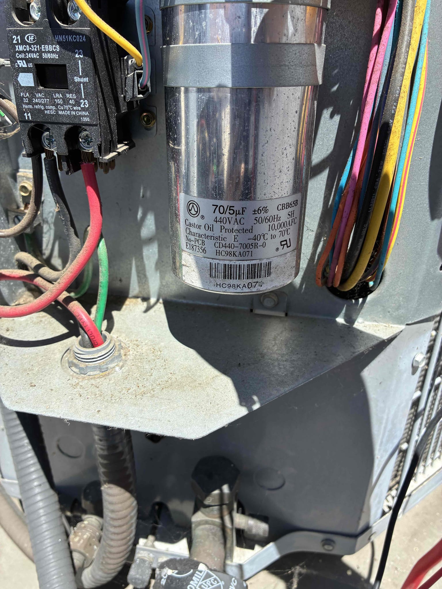 Upon inspection, the 2014 Carrier Heat Pump was not cooling effectively. The indoor blower fan was operational, but the air filter was dirty, hindering airflow. The evaporator coil was heavily soiled, further restricting airflow and reducing cooling efficiency. The outdoor condenser's fan was running, but the compressor was not. The dual run capacitor, rated at 70/5 MFD, was found to be significantly under its rated capacity, contributing to the compressor's failure to operate. I recommended replacing the dirty filter, installing a new dual run capacitor, adding a hard start kit, and cleaning the evaporator coil to restore proper system performance.