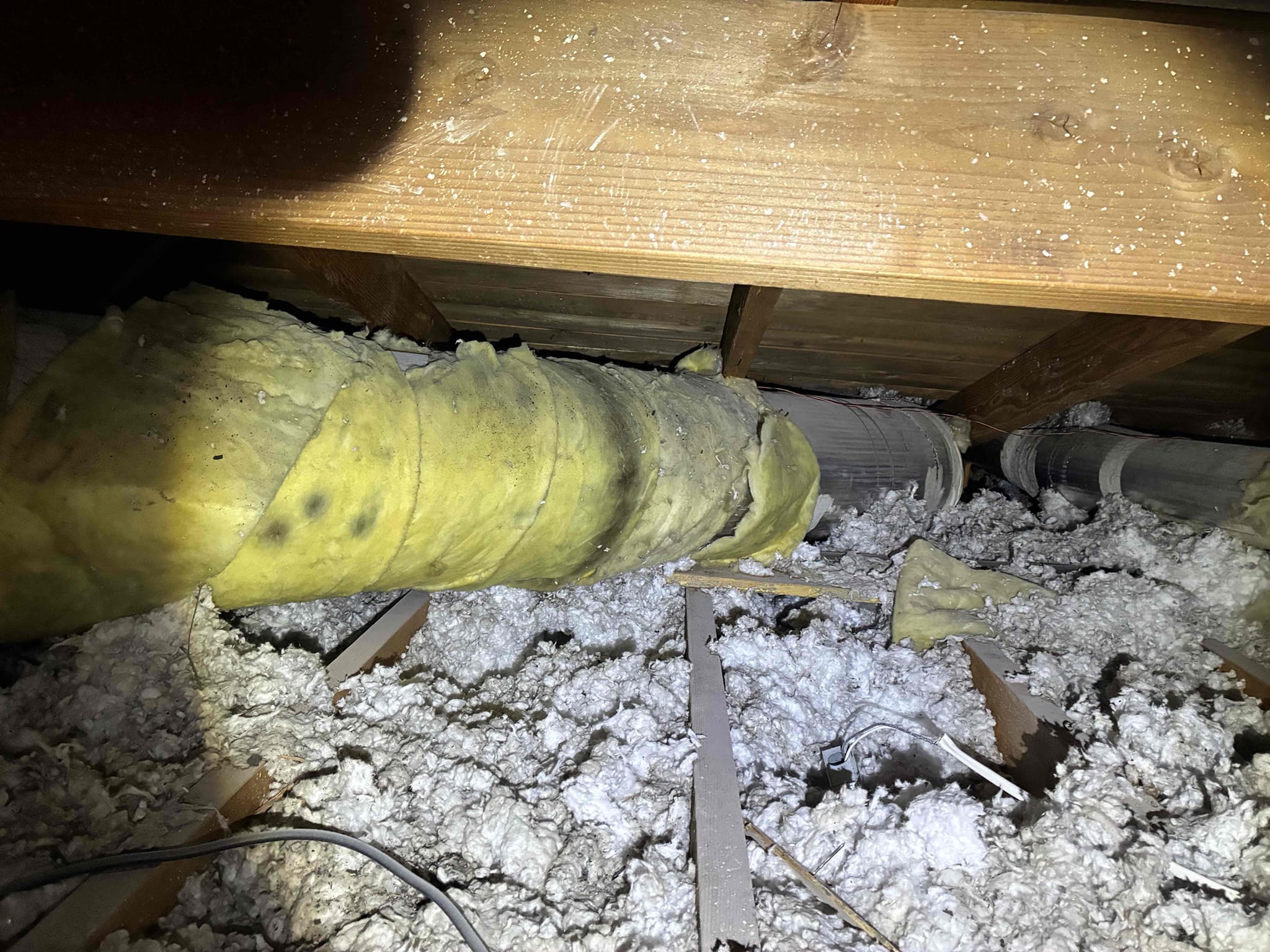I inspected a 1999 Rheem HVAC system, revealing neglected maintenance. The indoor blower wheel was clogged with dirt, and the motor showed rust. The evaporator coil was heavily soiled, reducing efficiency. The rooftop condenser had dirty coils, and the duct system had separated asbestos joints, causing air leaks. Due to asbestos, sealing the ducts was unsafe. I recommended replacing the entire system and ductwork to restore performance and indoor air quality.