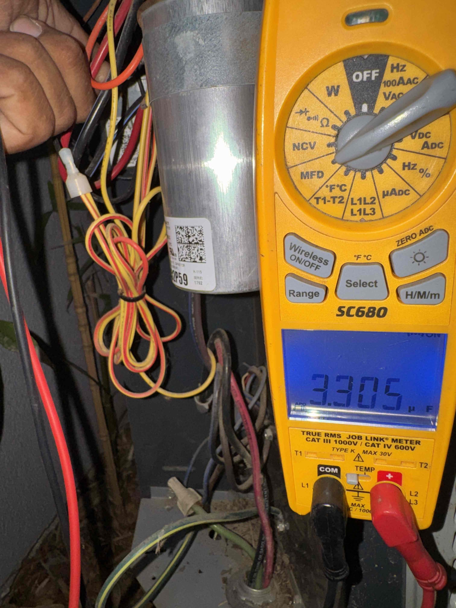 Upon arrival, I assessed the homeowner's concern about the system cycling without producing cool air. The unit in question is a 2014 American Standard 4-ton R410A system. Inspection revealed that the outdoor unit was heavily soiled with dirt, debris, and surrounded by foliage, hindering proper airflow. The 7.5 µF condenser fan capacitor tested at 3.3 µF, indicating failure and potential intermittent fan operation. While operating, the system showed a temperature split that improved from 19.1°F to 24.4°F. I recommend replacing the failed capacitor, thoroughly cleaning the outdoor coil, and removing all foliage and debris around the unit to restore proper airflow and system reliability.