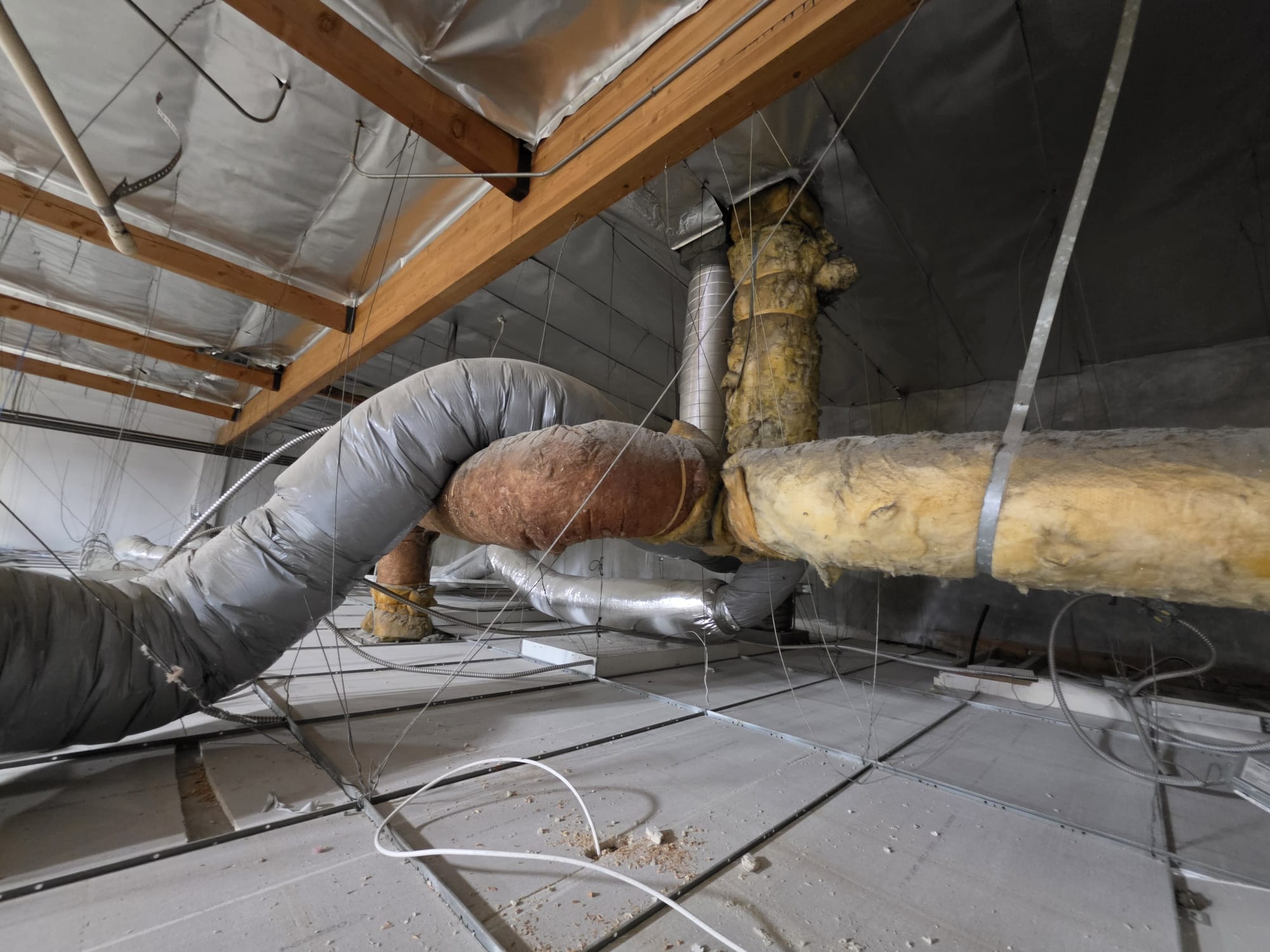 During the service inspection, I identified several critical issues with the existing ducting system. The ducting was predominantly old and leaking above the T-bar, which compromised the system's efficiency. Additionally, the ducting was not balanced properly, leading to uneven air distribution. The returns were not installed correctly, hindering optimal air exchange in a commercial setting. To enhance the system's performance, I recommended installing fresh air intake at the return plenum before the filter. Until the ducting system is replaced, the space will not achieve proper cooling.