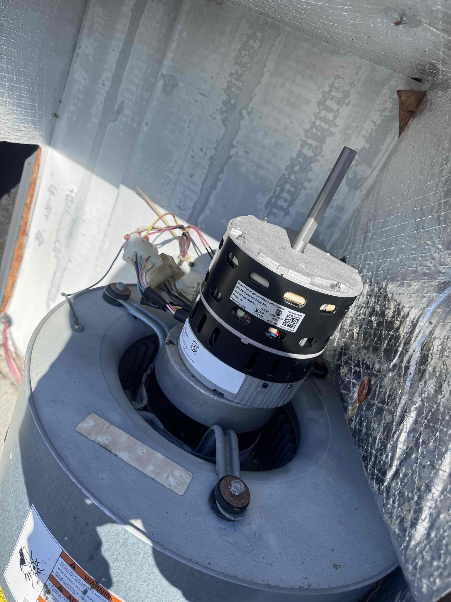 Upon diagnosing the HVAC system, the indoor blower motor failed to start despite proper power supply, ground, and low-voltage speed command. The blower wheel rotated freely, but the ECM motor did not respond. A failed programmed ECM blower motor/module was confirmed. The complete blower motor assembly was replaced with a 1/2 HP, 208/230V programmed ECM blower motor. The old motor was disconnected, and the blower wheel, housing, wiring, and mounting components were inspected. The new motor was installed, and all connections were reestablished. System performance was tested to confirm proper cooling and heating airflow settings, amperage, airflow, temperature split, and overall system performance.