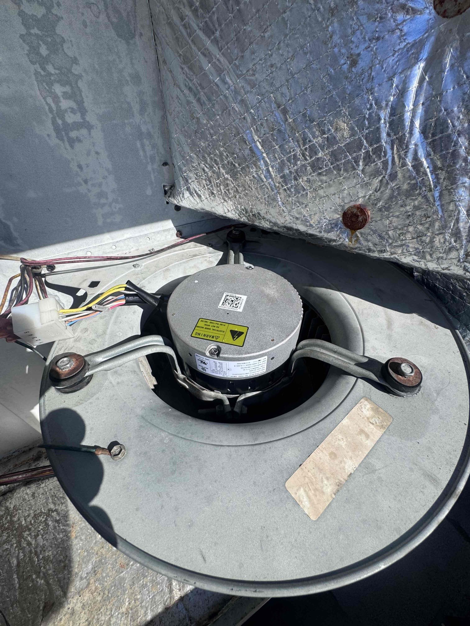 Upon diagnosing the HVAC system, the indoor blower motor failed to start despite proper power supply, ground, and low-voltage speed command. The blower wheel rotated freely, but the ECM motor did not respond. A failed programmed ECM blower motor/module was confirmed. The complete blower motor assembly was replaced with a 1/2 HP, 208/230V programmed ECM blower motor. The old motor was disconnected, and the blower wheel, housing, wiring, and mounting components were inspected. The new motor was installed, and all connections were reestablished. System performance was tested to confirm proper cooling and heating airflow settings, amperage, airflow, temperature split, and overall system performance.