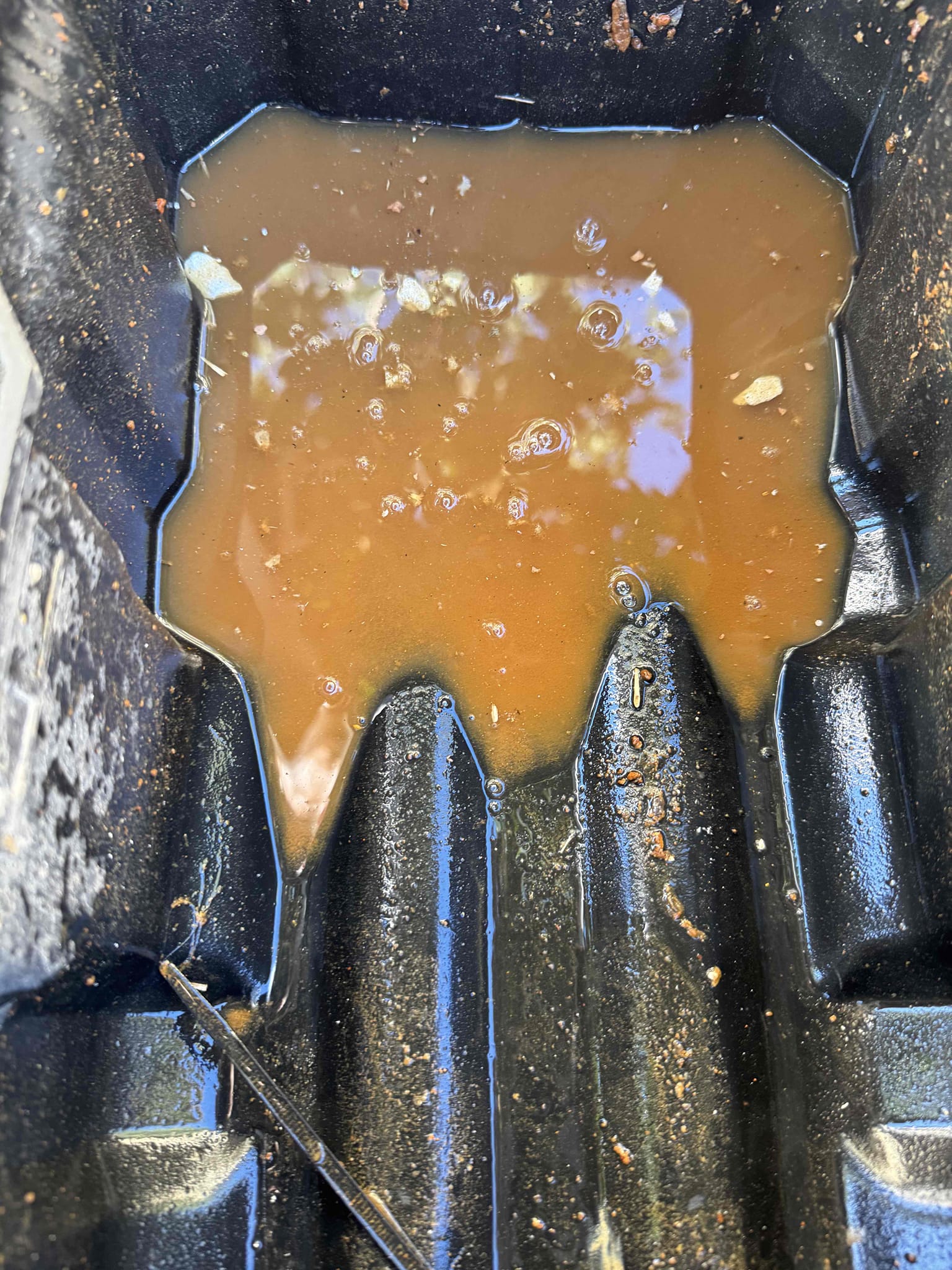 I inspected an 18-year-old, 3-ton R-22 heat-pump system. The primary condensate drain, located beneath the bathroom sink, had a significant blockage, causing condensate to back up and overflow from the fan coil’s drain pan. I vacuumed out the standing water and debris as a temporary solution, but this did not fully clear the drain. The pan exhibited considerable rust and corrosion. I recommend a thorough drain-line clearing and the addition of pan tabs to prevent future buildup. The outdoor unit, manufactured in April 2008, is model 13PJA36A01.