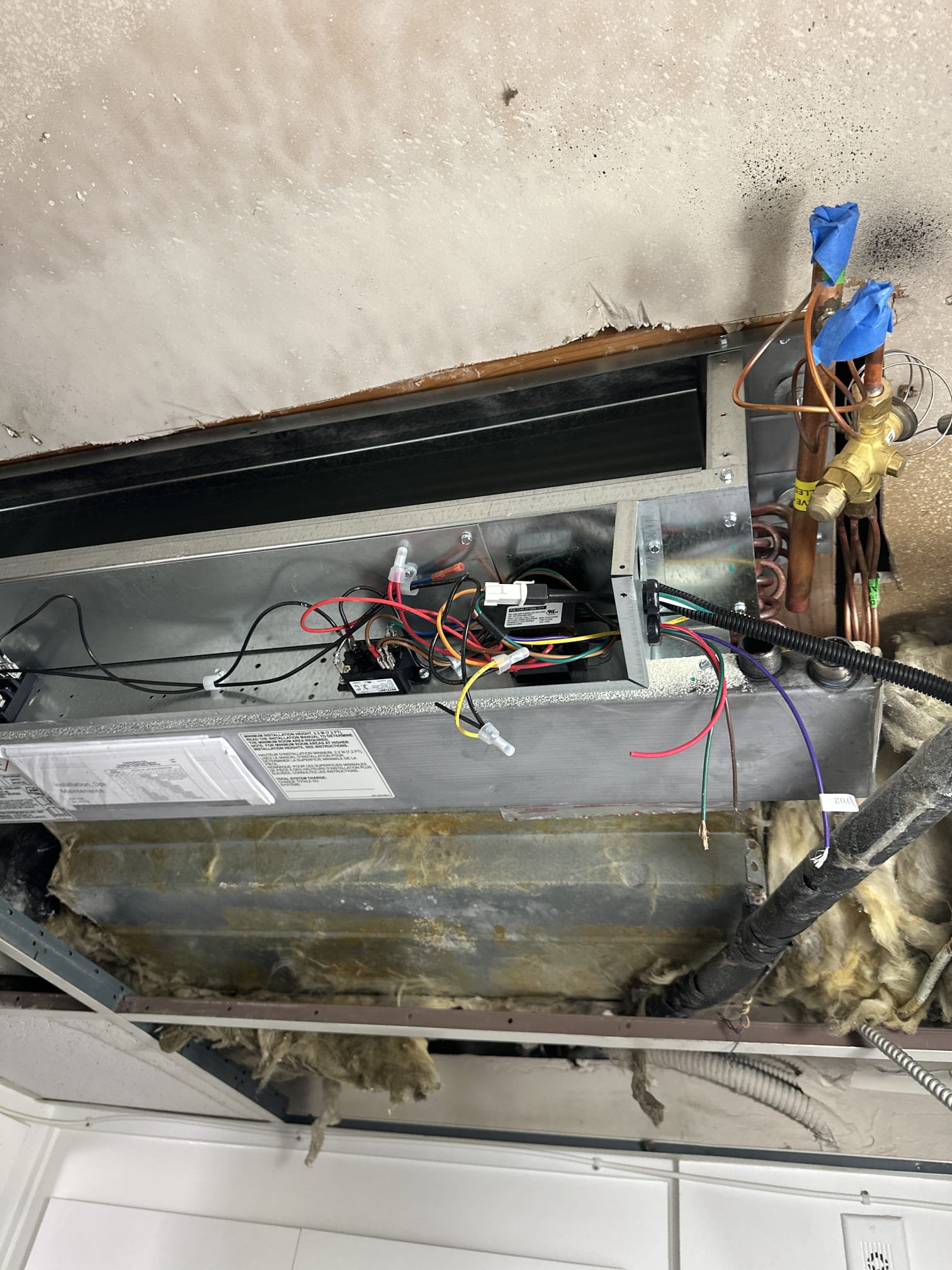 On the installation date, our team removed and hauled away the existing HVAC equipment. We installed a Carrier Comfort 2-ton up to 18 SEER2 Inverter Heat Pump Condenser using R454B refrigerant. Additionally, we installed a 2-ton Carrier ceiling fan coil with R454 refrigerant, an electrical service disconnect box, electrical whip, SS2 safety shut-off switch, and a Braeburn 2030 thermostat. The line set was flushed, and connections were made to the existing low voltage line, supply plenum, and air ducts. This installation includes free maintenance, a 1-year labor warranty, and 10-year limited warranties on factory parts and the compressor. Payment is structured as a 10% deposit, 70% upon crew arrival, and 20% upon equipment startup. Permit and HERS test costs are included.