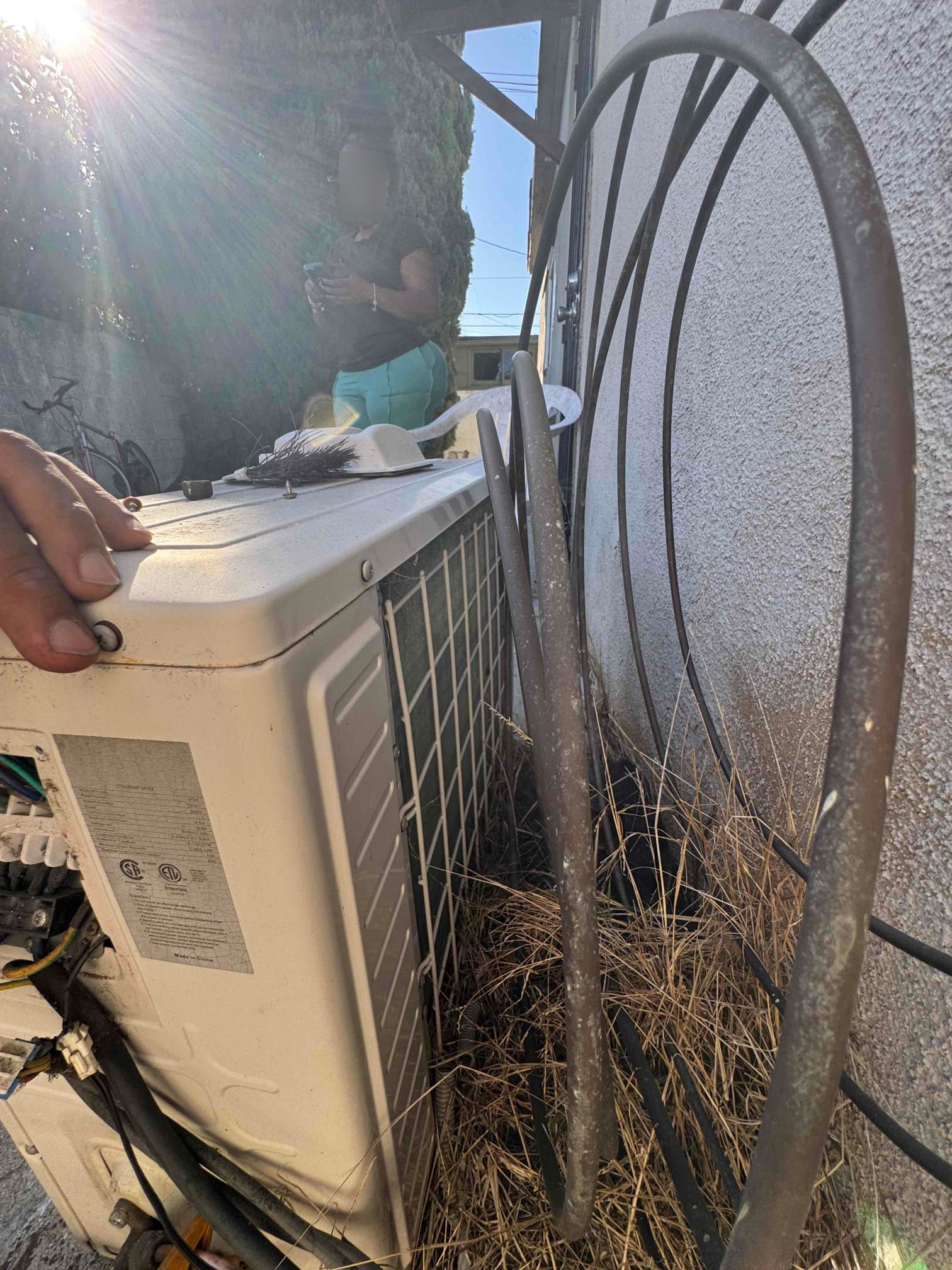 Upon inspection, the mini-split system's outdoor fan was operational, but the compressor hummed without starting. Testing revealed a failed compressor run capacitor rated at 55 µF. After installing a temporary capacitor, the compressor started, and the system resumed cooling, confirming the capacitor as the issue. The indoor filters were heavily restricted with dust and debris, impacting system efficiency. Due to the single refrigerant service port, a high-side pressure reading was unavailable. Further refrigerant evaluation would require manufacturer-specific procedures and operating conditions. Repair options include replacing the failed capacitor, and a replacement option for the aging system will be provided.