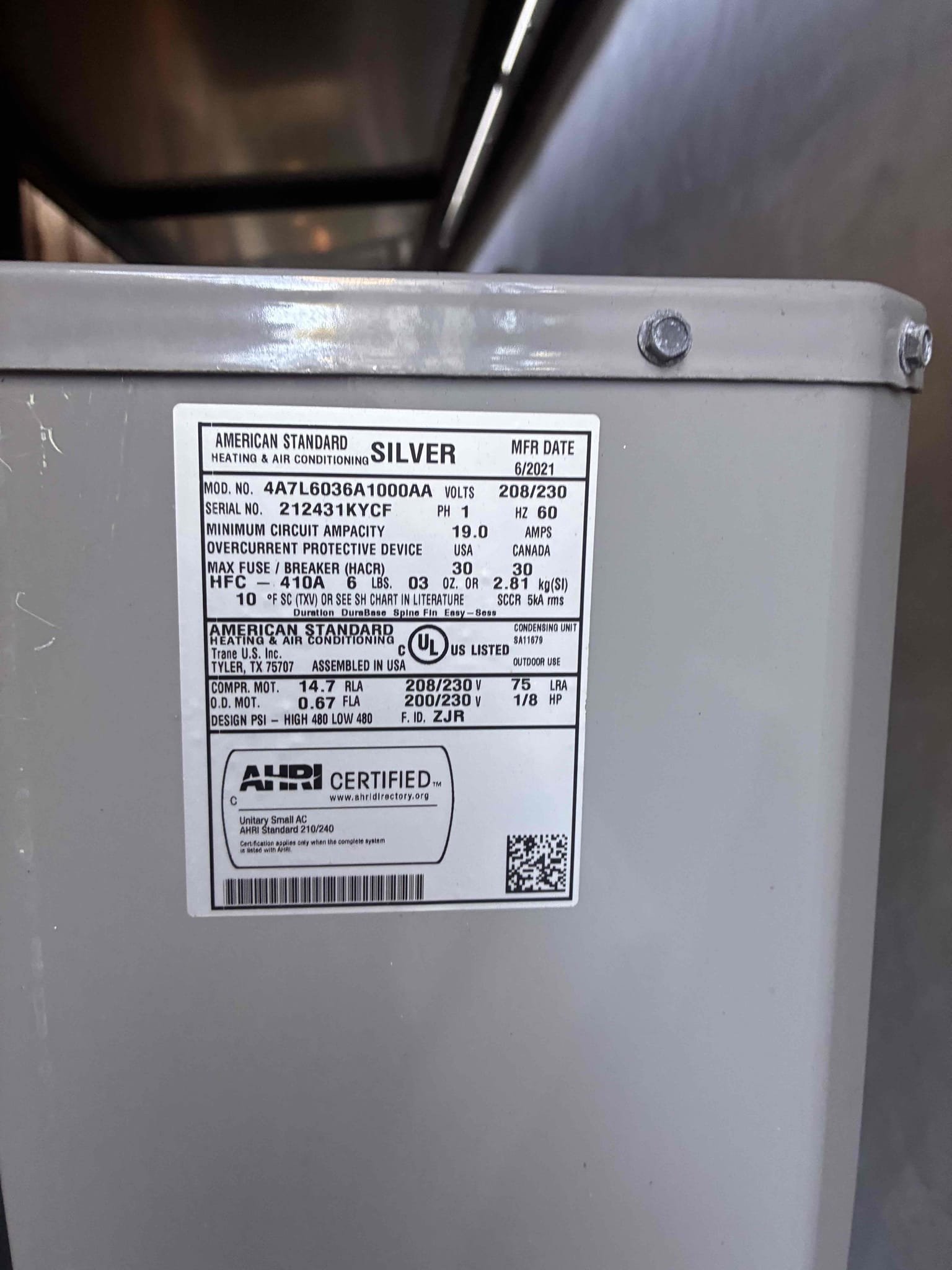 I inspected the downstairs HVAC system, a 2021 American Standard Silver 3 Ton Condenser, due to loud compressor noise, rattling, and excessive vibration. The compressor was straining during startup, producing excessive noise and vibration. I checked electrical components, amperage, and refrigerant pressures, finding suction pressure at 100 PSI, head pressure at 312 PSI, and subcooling at 0.9°F (target 10°F). The capacitor was fine, but the readings indicated a refrigerant-flow issue. I recommended replacing the compressor due to its mechanical condition. Alternatively, I suggested a temporary repair involving a new hard-start kit, capacitor replacement, and refrigerant top-off, though this is not guaranteed to resolve the issues.