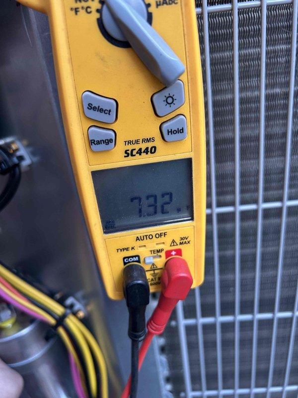 Performed care plan tune-up service on heat pump/gas furnace system located in basement. Inspected and tested dual run capacitor (45/7.5μF) using Fieldpiece multimeter which displayed reading of 732 microfarads, indicating capacitor is operating properly. Filter size verified as 16x25x1.