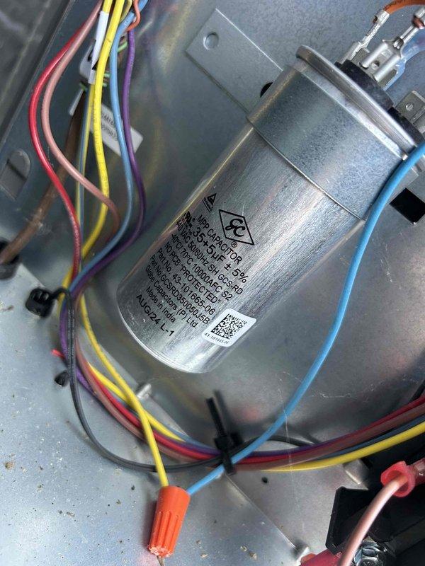 Completed care plan tune-up service on heat pump/air handler system located in garage. Performed visual inspection of capacitor and electrical connections, noting proper wiring configuration. Checked Honeywell thermostat operation, which displayed 60°F with 20% humidity and had active system alerts. Replaced existing filter with AprilAire #310 filter as part of maintenance protocol.