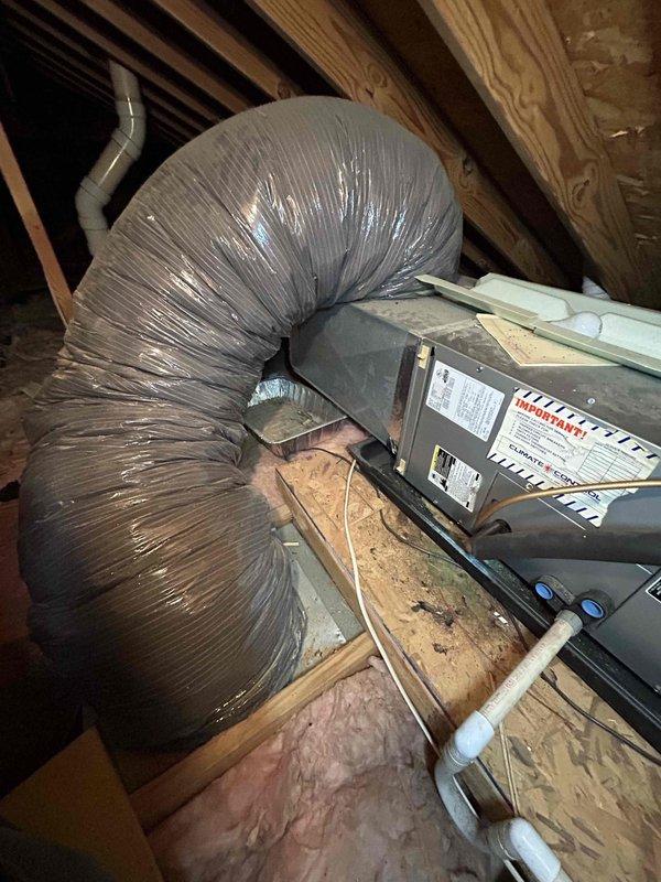 Conducted system replacement assessment on an 8-year-old electric HVAC system reported to be producing excessive noise/squealing audible to neighboring residents. Inspection of attic-installed air handler revealed deteriorating components contributing to the operational noise. Documented current installation configuration including flexible ductwork routing, electrical connections, and mounting structures to prepare comprehensive replacement quote for customer.