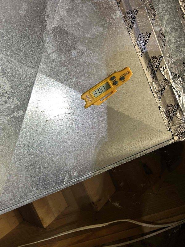 Performed annual maintenance service on a 10-year-old geothermal system located in the basement. Checked and verified thermostat operation (Bryant digital) which was set to "follow schedule" and displaying proper heat functionality. Conducted moisture readings with measurement device showing acceptable levels (31.0) during inspection of the system components.