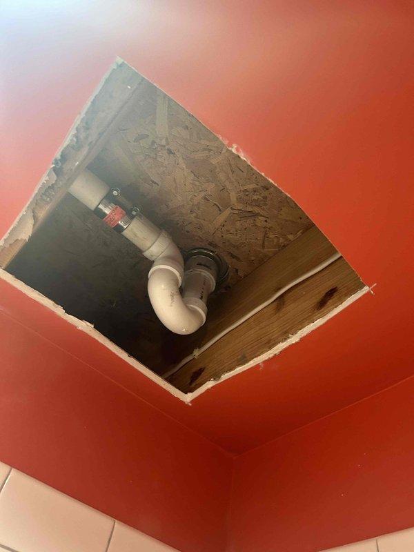 Completed repair of shower drain system requiring ceiling access for proper inspection and service. Cut access opening in ceiling to expose damaged piping, removed old shower basket, and installed new shower basket assembly. Reconnected to existing drain line and verified proper drainage and absence of leaks before finalizing repair.