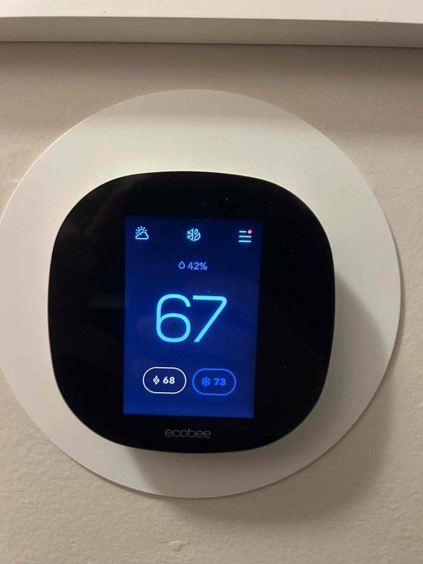 Performed scheduled Care Plan Tune Up on AC/GF system located in garage. Inspected ecobee smart thermostat functionality, confirmed proper operation with temperature reading at 67°F and humidity at 42%. Verified system threshold settings including compressor cycle parameters (300 second minimum off time) and minimum outdoor temperature settings (50°F).