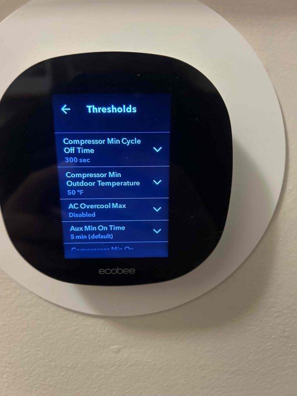 Performed scheduled Care Plan Tune Up on AC/GF system located in garage. Inspected ecobee smart thermostat functionality, confirmed proper operation with temperature reading at 67°F and humidity at 42%. Verified system threshold settings including compressor cycle parameters (300 second minimum off time) and minimum outdoor temperature settings (50°F).