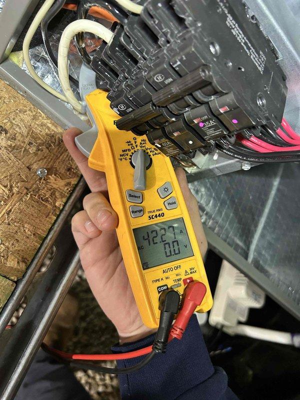 Diagnosed electrical malfunction in HVAC system traced to thermostat programming issue. Performed hard reset of thermostat and reprogrammed it to properly operate with 15 KW heat kit, resolving insufficient heating caused by partial heat strip activation. Verified proper amp draw with Fieldpiece SC440 clamp meter during system operation.