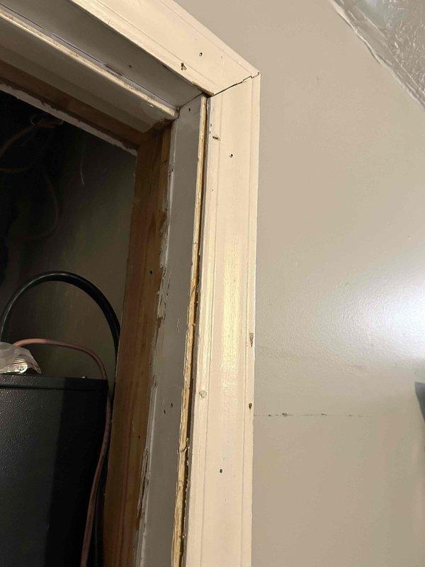 Documented equipment model/serial numbers via photographic documentation and established plan to return for door framing modifications to properly accommodate HVAC closet access. Identified 2x4 lumber requirements for furring out the closet door frame according to Wayne's specifications.