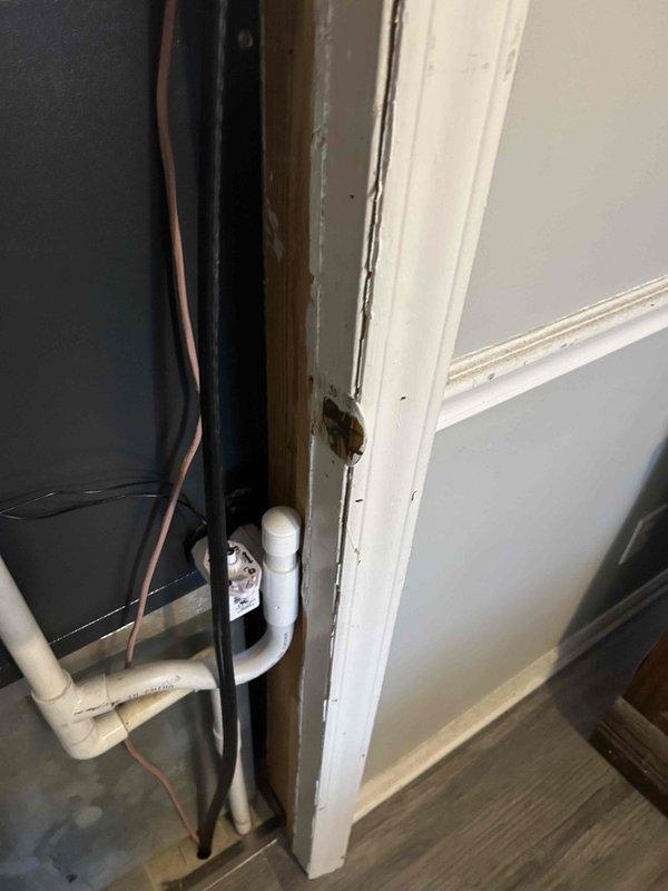 Documented equipment model/serial numbers via photographic documentation and established plan to return for door framing modifications to properly accommodate HVAC closet access. Identified 2x4 lumber requirements for furring out the closet door frame according to Wayne's specifications.