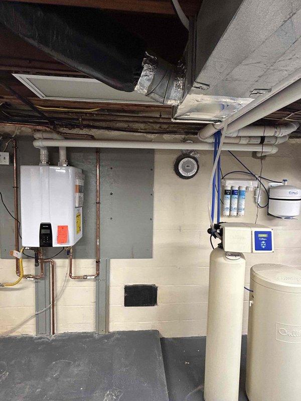 Completed installation corrections for failed tankless water heater inspection. Extended fresh air intake to exterior of home and shortened relief line to proper height above floor as required by code. Verified proper operation of unit after modifications were completed.