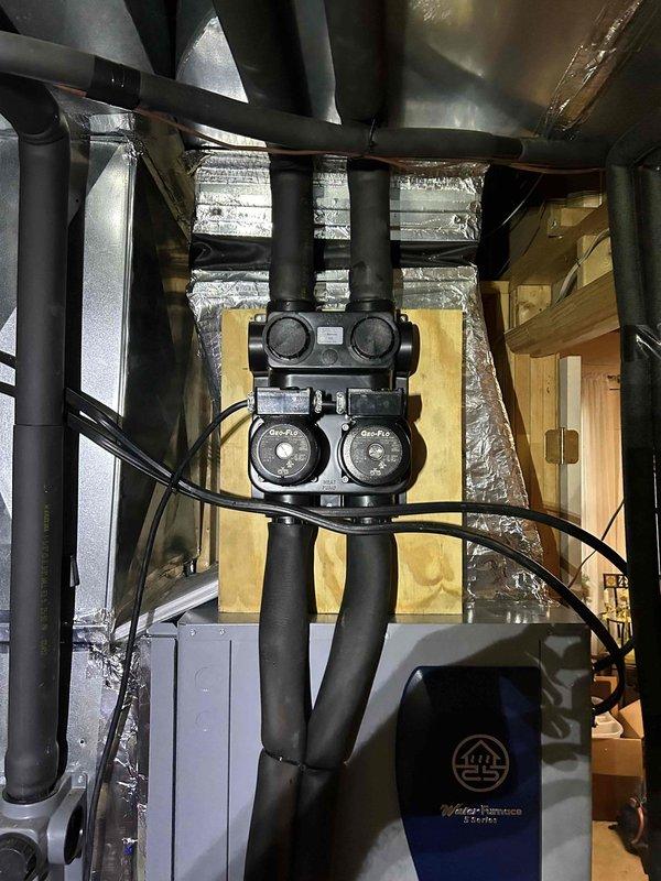Successfully installed a WaterFurnace 5 Series W5AV060BD1A12CTL2B01 5-ton two-stage geothermal heat pump with variable speed blower, water heater desuperheater, and 20kW auxiliary heat kit. System installation included new dual pump flow center with hose kit, reconnection to existing geothermal loop piping with complete system flush and fill, reconnection to existing PEX water heater piping, and integration with customer's Honeywell 9000 series thermostat. All old equipment was removed and properly disposed of, with installation completed in compliance with local permit requirements.