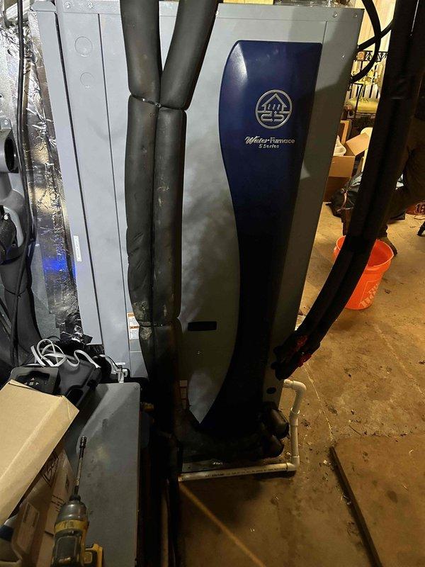 Successfully installed a WaterFurnace 5 Series W5AV060BD1A12CTL2B01 5-ton two-stage geothermal heat pump with variable speed blower, water heater desuperheater, and 20kW auxiliary heat kit. System installation included new dual pump flow center with hose kit, reconnection to existing geothermal loop piping with complete system flush and fill, reconnection to existing PEX water heater piping, and integration with customer's Honeywell 9000 series thermostat. All old equipment was removed and properly disposed of, with installation completed in compliance with local permit requirements.